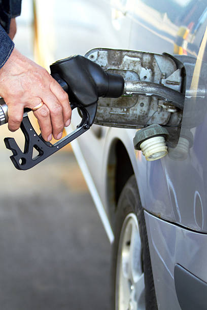 Buying diesel pumping gas on petrol station stock photo