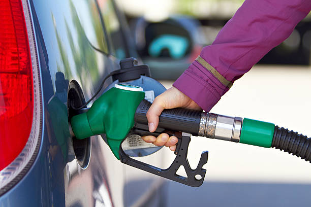 Buying petrol pumping gas global warming car stock photo
