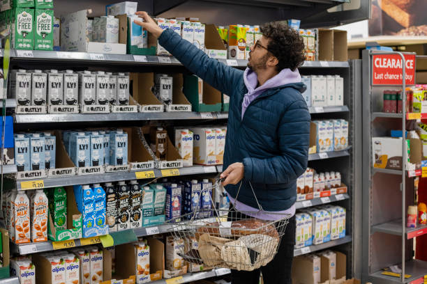 buying vegan alternative milk - food stockfoto's en -beelden