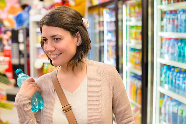 buying water - soda supermarket stockfoto's en -beelden
