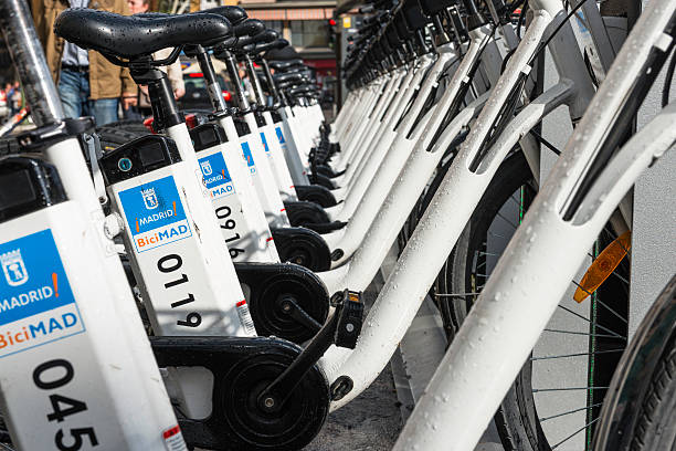 bycicles docked on a bicimad bike station in madrid - clean saddle bildbanksfoton och bilder