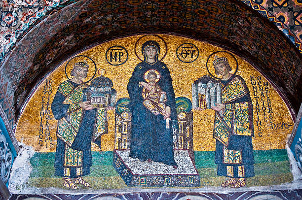 Byzantine mosaics at the Hagia Sophia in Istanbul, Turkey Above an entrance to the Byzantine-era church of Hagia Sophia in Istanbul, a tenth-century mosaic depicts Justinian the Great (left) presenting a model of the Hagia Sophia to the Virgin Mary and infant Jesus. On the right, Constantine is presenting a model of city. byzantine stock pictures, royalty-free photos & images