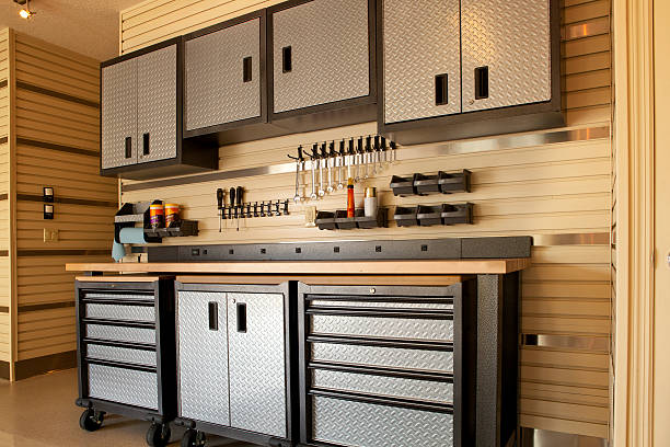 Cabinets and rolling table in garage workspace "Garage workspace with cabinets, countertop and tools" neat photos stock pictures, royalty-free photos & images