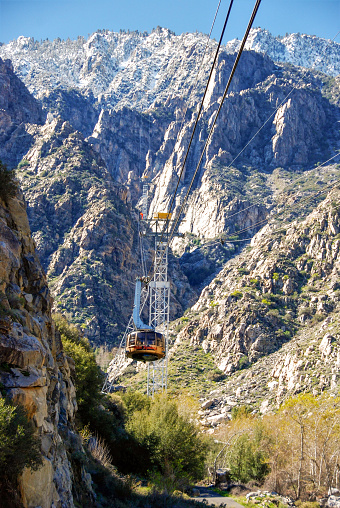 Palm Springs, California, USA - February 2017: Cable car on the aerial ropeway which takes visitors to the summit of  the San Jacinto mountain. The size of the cable car shows the scale of the mountain
