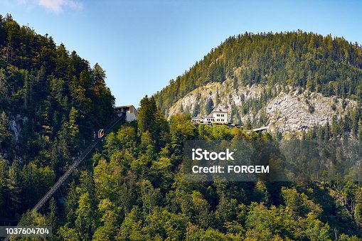 istock Cable car, forest and mountains over the Austrian city of Hallstatt, under a blue sky with clouds 1037604704