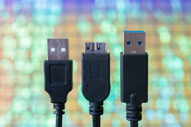 USB cable plug faces with tech background stock photo