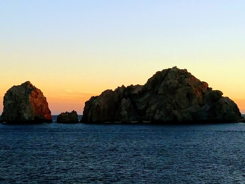 Cabo san lucas sea of cortez sunset with cliffs in shadows