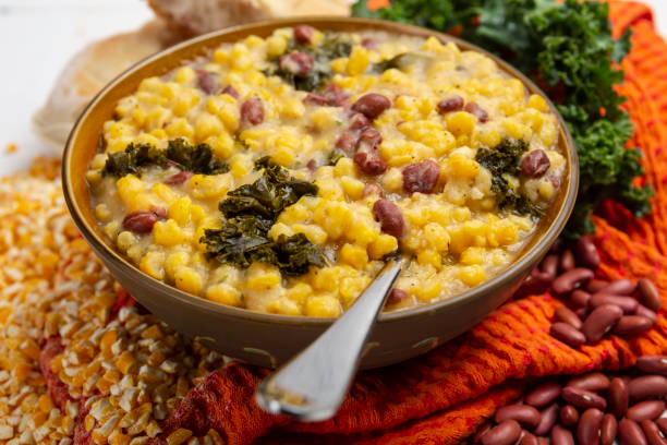 Cachupa, A hearty vegan delicious Cape Verdean stew packed with fresh, flavor veggies, traditional hominy corn soup or stew and Portuguese bread stock photo