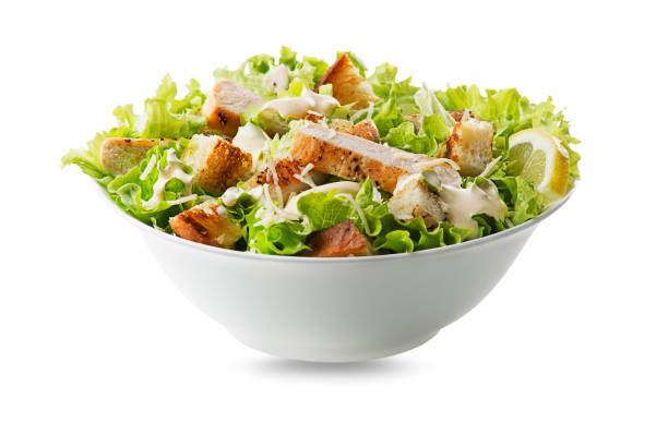 Caesar Salad with grilled chicken and croutons of bread Chicken Salad. Chicken Caesar Salad. Caesar Salad with grilled chicken and croutons. Grilled chicken breast and fresh green salad isolated on white chicken salad stock pictures, royalty-free photos & images