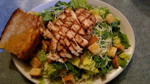 Caesar Salad with Grilled Chicken and Texas Toast, Top View, Close Up stock photo