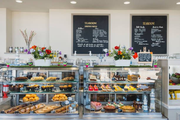 Cafe counter containing cakes and desserts for sale Delicatessen interior with service counter and food on display, food and drink, cafe, tearoom display cabinet stock pictures, royalty-free photos & images