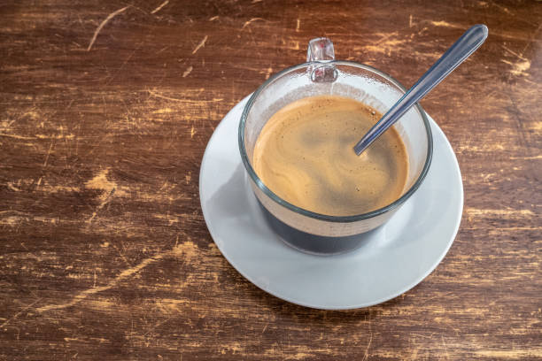 Cafe Cubano in in a glass mug on a wooden table stock photo