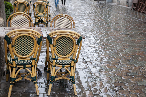 Cafe Tables and Chairs in Wet Rainy Street, Brussels; Belgium