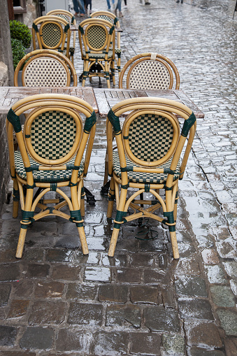 Cafe Tables and Chairs in Wet Rainy Street in Brussels; Belgium