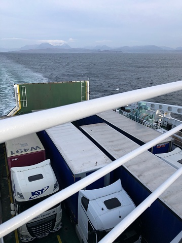 Ullapool, Scotland, United Kingdom - April 12, 2022: Heavy goods vehivles on a Caladonian MacBrayne passenger and vehicle ferry travelling from Ullapool to Stornaway