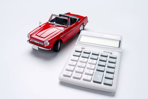 Calculator and sports car isolated on white background Calculator and sports car isolated on white background car loan stock pictures, royalty-free photos & images