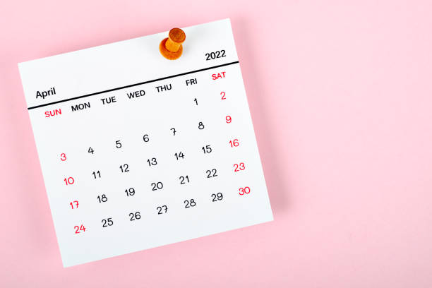 Calendar desk 2022 in April, The concept of planning and deadline with a push pin on the calendar date. stock photo