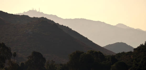 California Morning Contrasts. Layers of hills with communication towers around Lake Hodges silhouetted in the golden morning. lake hodges stock pictures, royalty-free photos & images