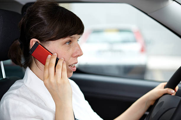 calling and driving a car stock photo
