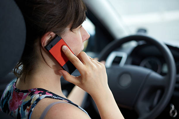 calling phone and driving a car stock photo