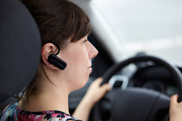 calling with bluetooth headset and driving car stock photo