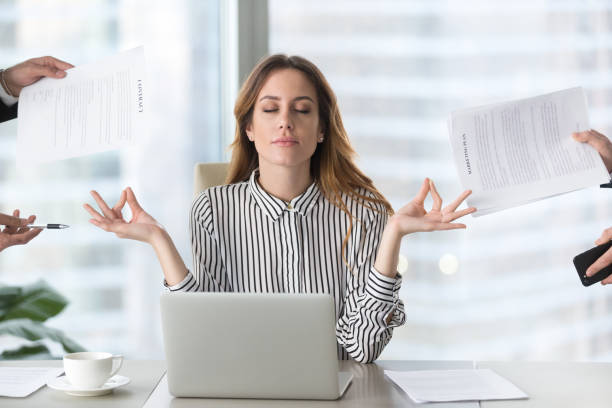 Calm female executive meditating taking break avoiding stressful job Calm female executive meditating taking break at work for mental balance, mindful businesswoman feeling relief and no stress doing yoga at work ignoring avoiding stressful job and paperwork in office execise in hectic life stock pictures, royalty-free photos & images