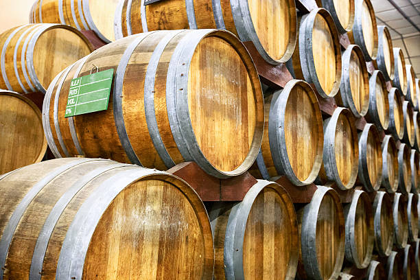 Calvados barrels in storage at the plant in Normandy, France photo made at a factory for the production of Calvados in Normandy, France calvados stock pictures, royalty-free photos & images
