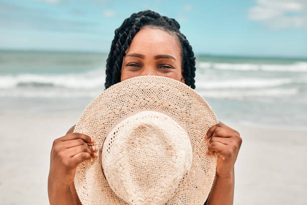 I came prepared to the beach with my most stylish hat Portrait of an attractive young woman spending some time at the beach braided hair photos stock pictures, royalty-free photos & images