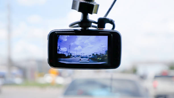 Camera on the front of a car Background Cars on the road and clouds in the sky. stock photo
