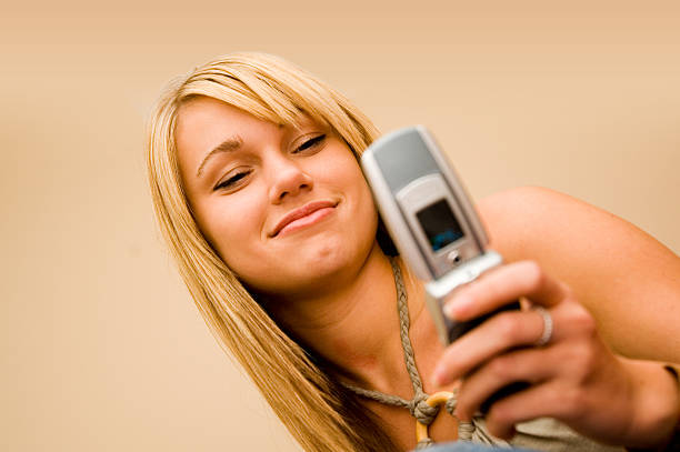 Camera Phone (Young Woman in Focus)  hf7 stock pictures, royalty-free photos & images