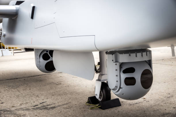 Camera sensor pods under an unmanned aerial surveillance drone aircraft. stock photo