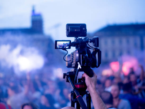 Cameraman Live tv broadcasting crowd in the street stock photo