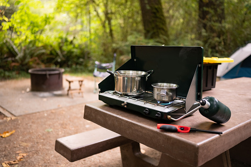 This is a photograph of a camping stove cooking setup at a Del Norte campground in Redwood National Park, California, USA.