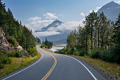 istock Camper travels along a curving highway in Alaska below mountains near Seward on a sunny afternoon 1320549628