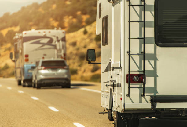 Camper Van and Diesel Pusher Motorhome on a Highway. stock photo