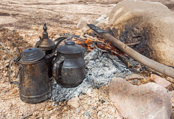 Campfire with cooking pots in hot desert climate stock photo