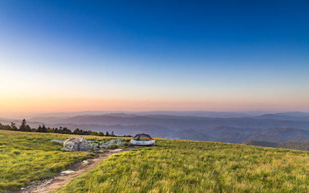Camping on mountaintop at sunset stock photo