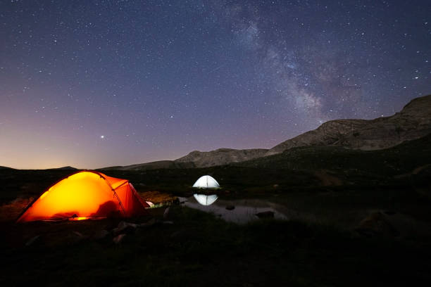 camping tent and night sky stock photo