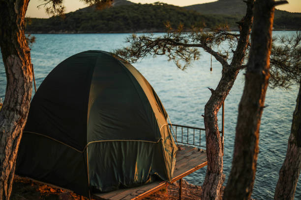 Camping, Tent Life, Summer Activity, Relaxation And a Peaceful Holiday in Nature Camping, Tent Life, Summer Activity, Relaxation And a Peaceful Holiday in Nature finistere stock pictures, royalty-free photos & images