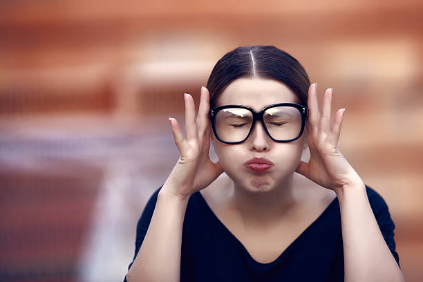 I can not take it anymore portrait of angry and painful student with her eyes closed, angry expression and headache.wearing eyeglasses. complaining stock pictures, royalty-free photos & images
