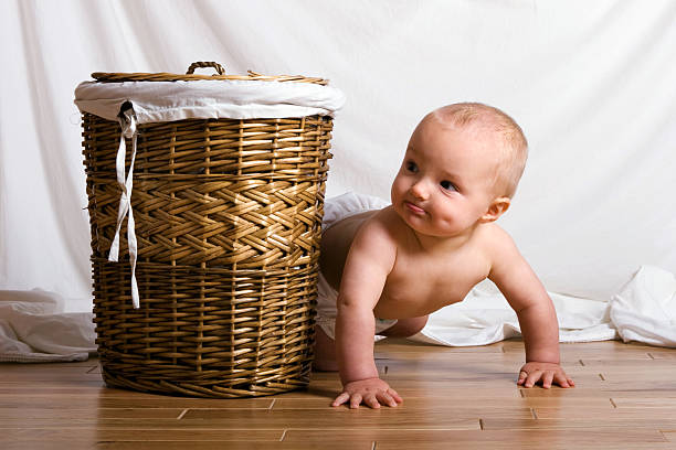 Can they see me? - Baby playing hide and seek stock photo