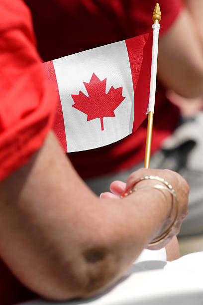 Canada day celebrations holding canadian flag stock photo