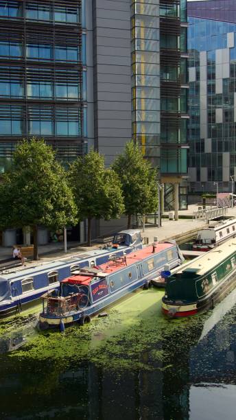 Canal Boats, Paddington Basin, London Morning shot of narrow boats moored in the Paddington Basin off the Regent's Canal, London. skeable stock pictures, royalty-free photos & images
