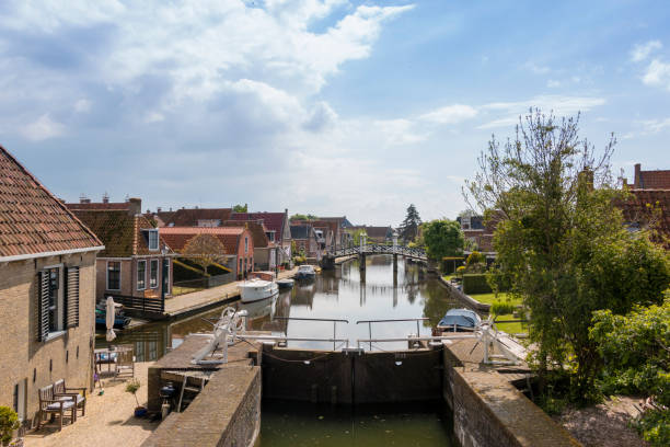 A canal with lock in a historical city in the lake side district of the Netherlands. stock photo