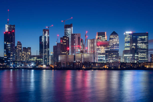 Canary Wharf Business District Skyline at Night Night Time Skyline View of Modern Business District Canary Wharf in London, UK. canary wharf stock pictures, royalty-free photos & images