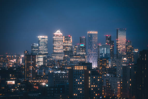 Canary Wharf Skyline view at night - Financial hub in London, United Kingdom Aerial panoramic view of The City of London cityscape skyline with metropole Canary Wharf financial district modern skyscrapers at night with illuminated buildings in London, UK canary wharf stock pictures, royalty-free photos & images