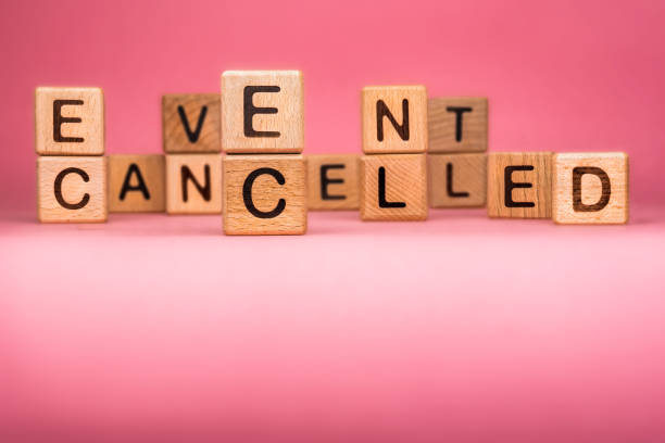 Cancel word on wooden cubes. Cancelled word made with building blocks. Mass gathering cancelled. Repatriation and quarantine of travellers. Travel advice. Protect from coronavirus infection CANCELLED word made with building blocks, business concept. Word CANCELLED on pink background. Global mass gathering cancelled. Cancelled background, Plan changing entertainment event stock pictures, royalty-free photos & images
