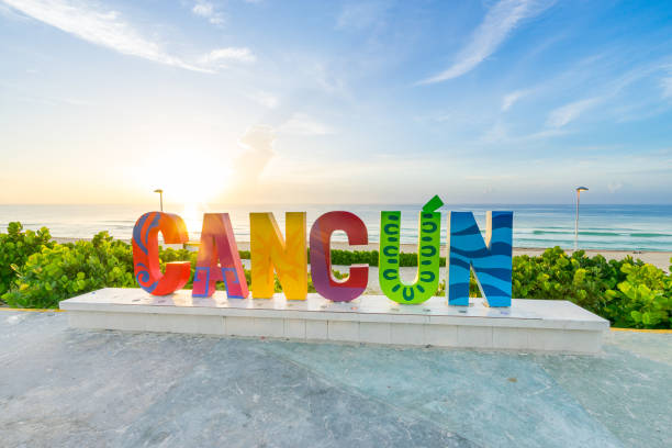 Cancun sign at sunrise The Cancun sign at sunrise at Playa Delfines a popular beach in Cancun, Mexico cancun stock pictures, royalty-free photos & images