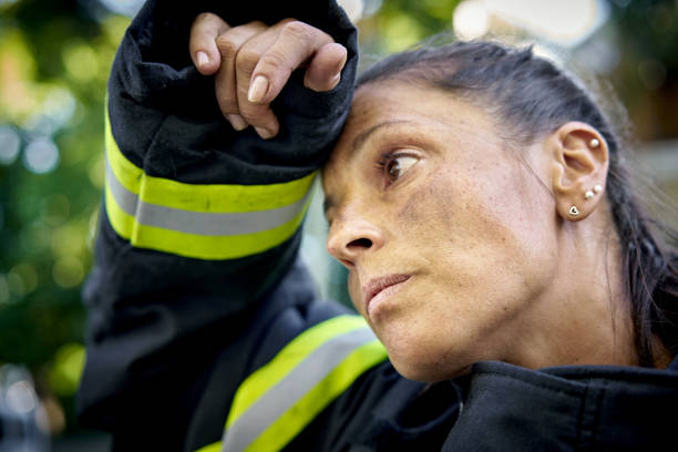 Candid Portrait of Exhausted Hispanic Female Firefighter stock photo