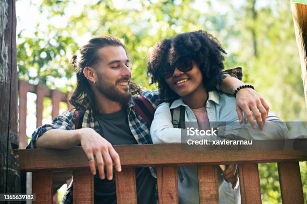 Candid portrait of young couple enjoying vacation in nature